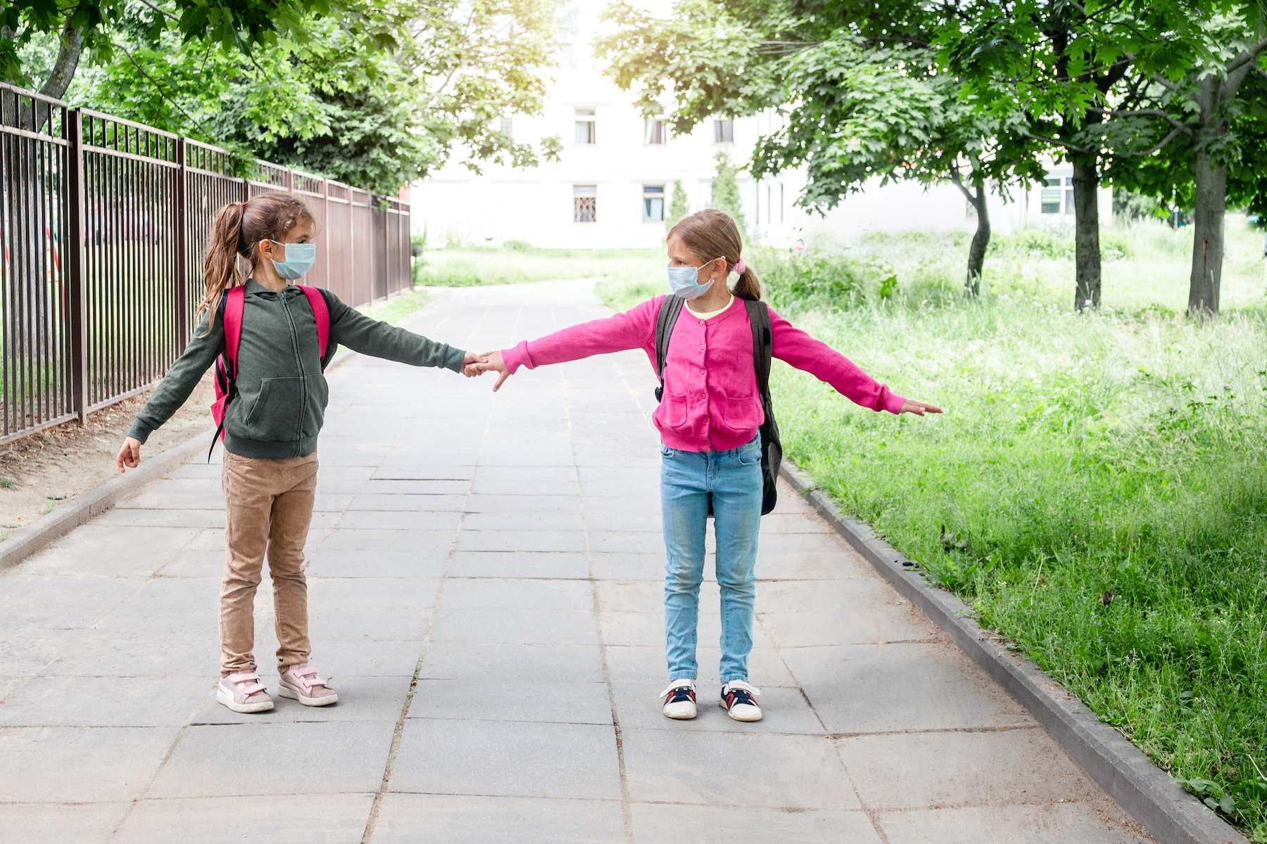 Girls masked holding hands
