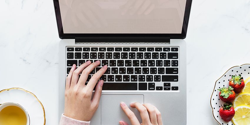 Hands working on a computer