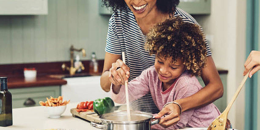 Mom and daughter cooking together