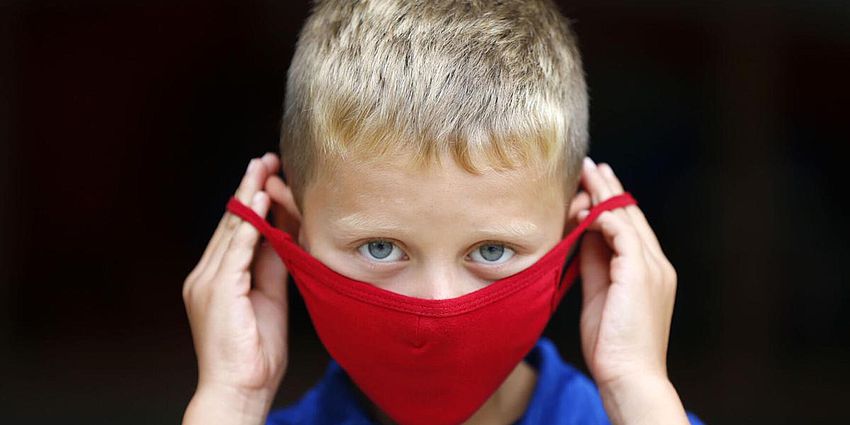 student placing mask on or off
