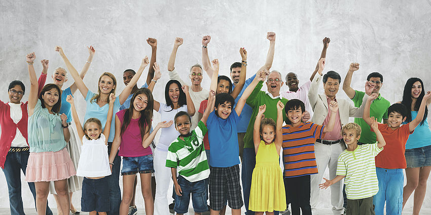 groups of smiling people with hands raised