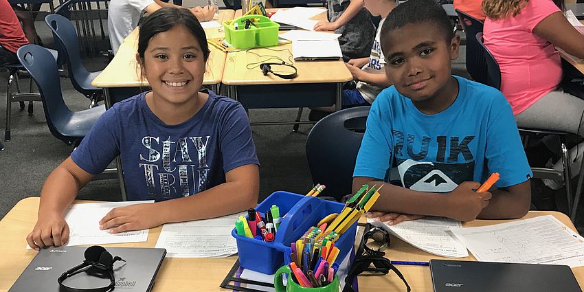 Two students at their desks