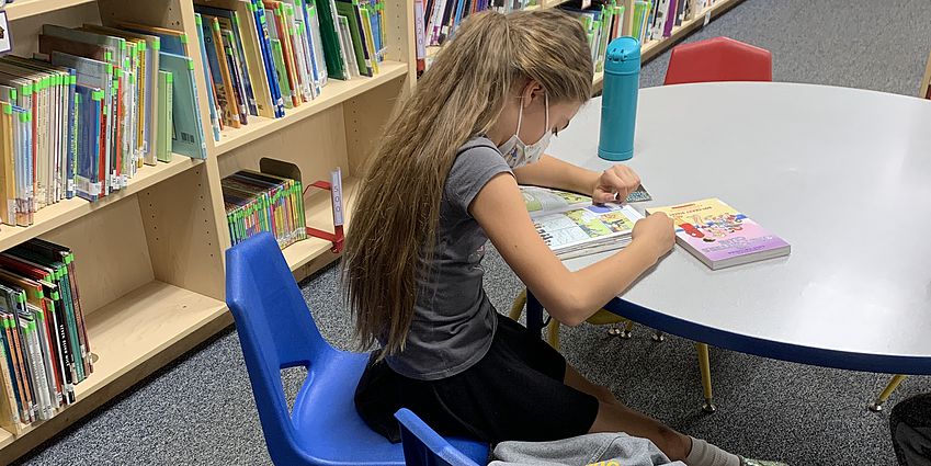 Student reading in the library