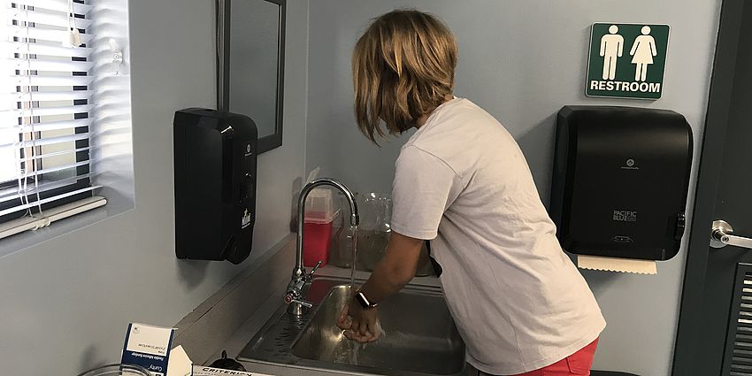 Student washing her hands