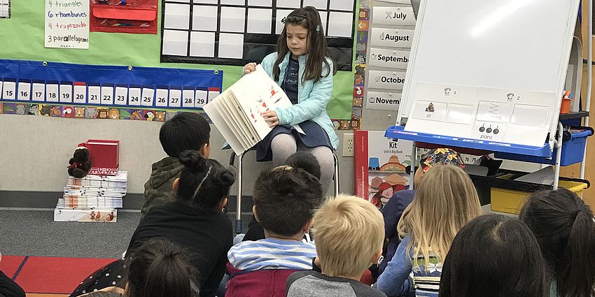 The Principal reading to students