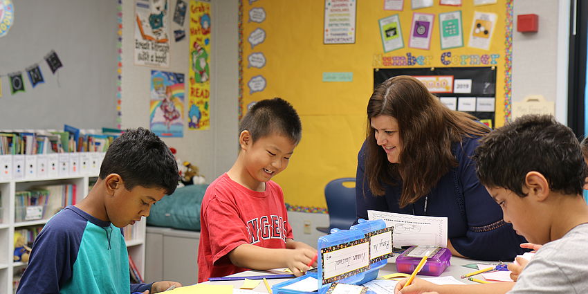 teacher working with students