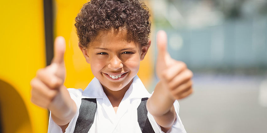 child with both thumbs up