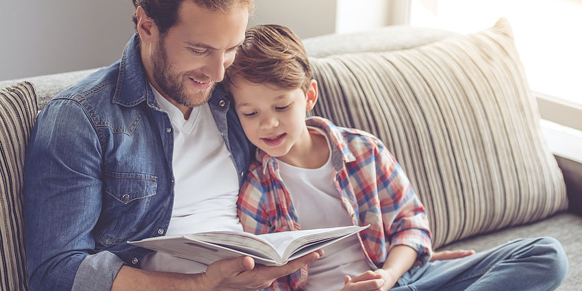 Dad and son reading a book