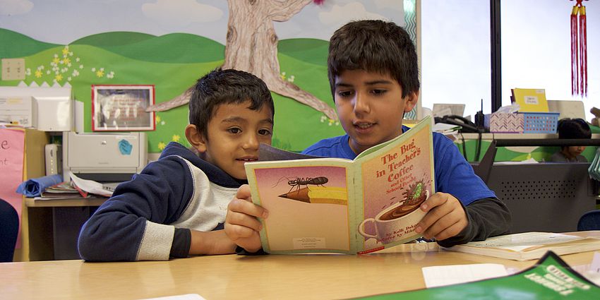 two boys reading together