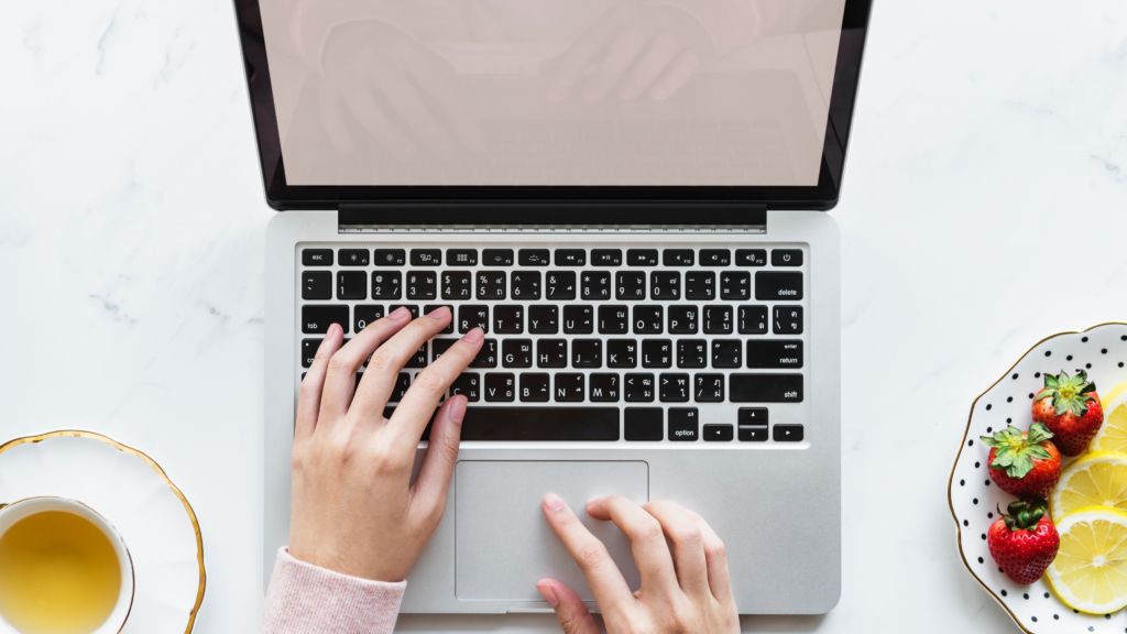 Hands working on a computer