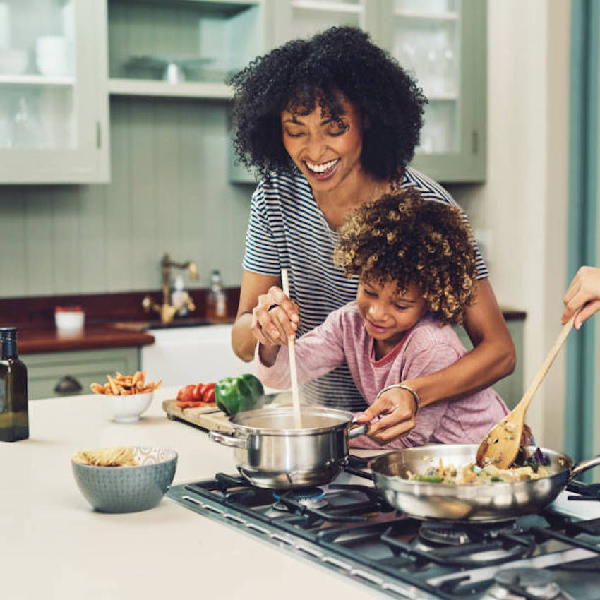 Mom and daughter cooking together