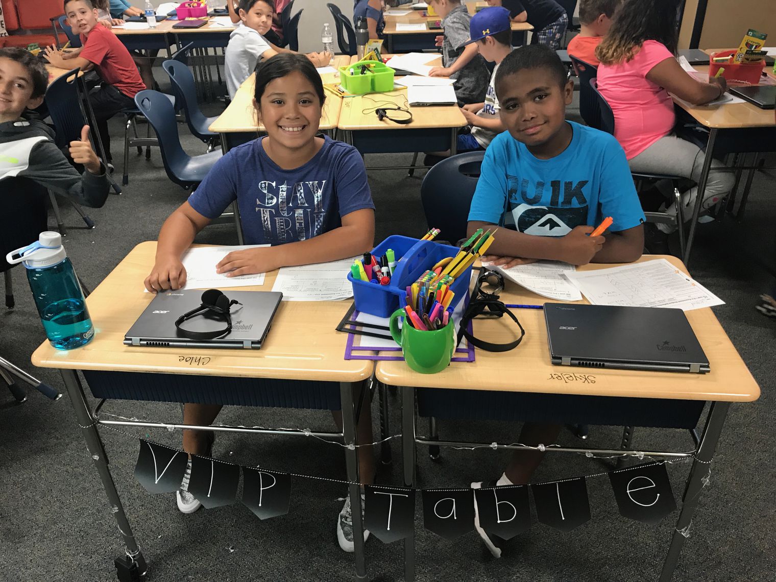 Two students at their desks