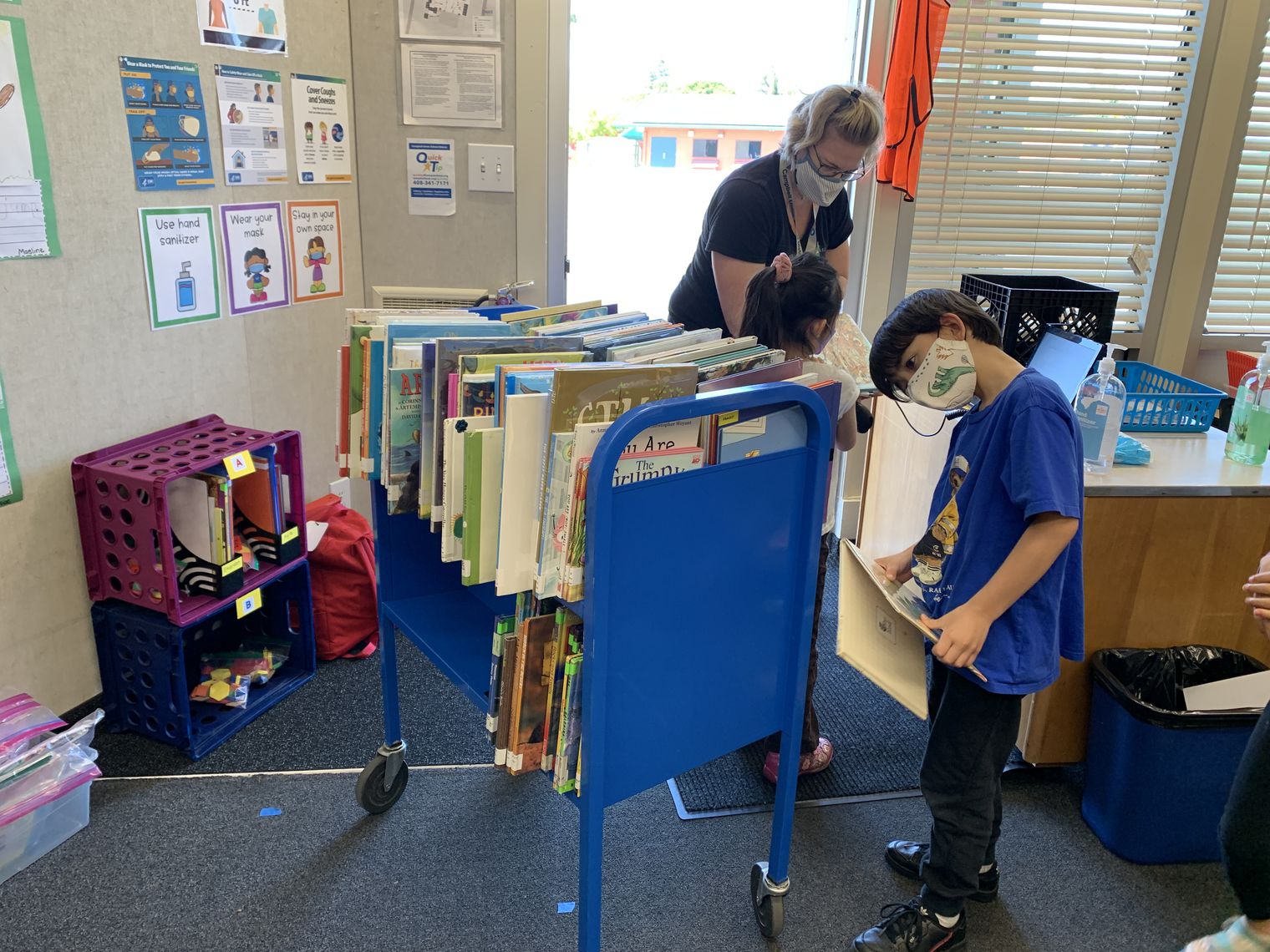 A student looking at a library cart