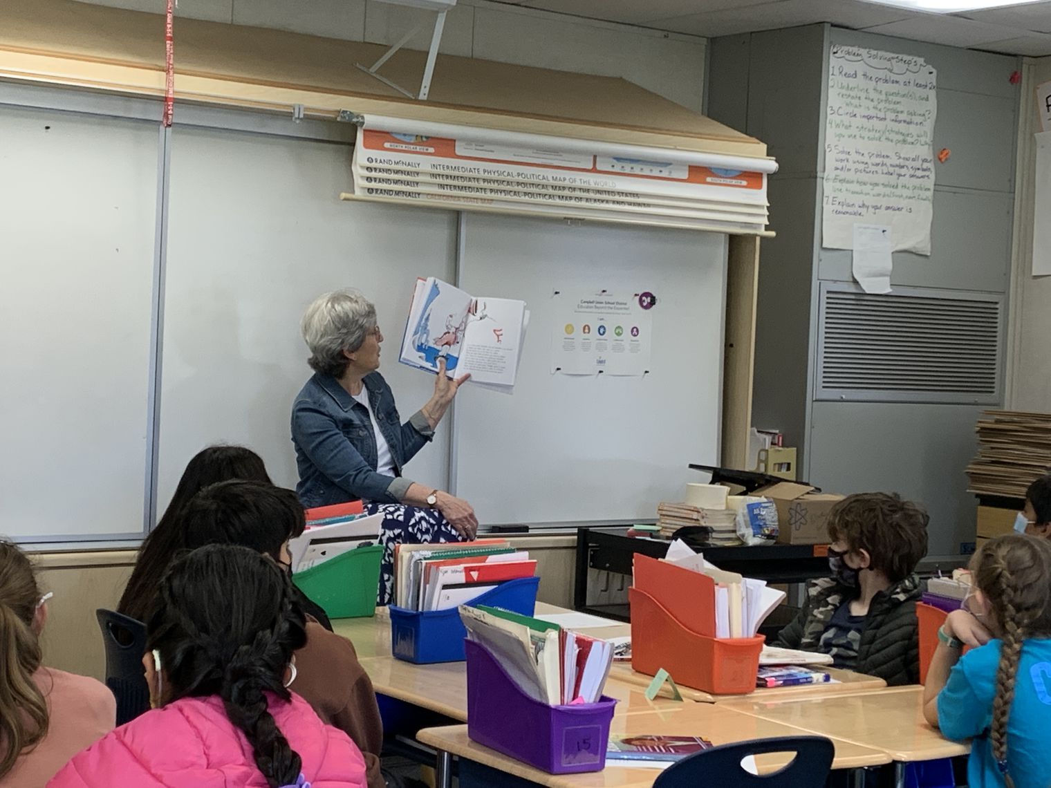 A volunteer reading to a class