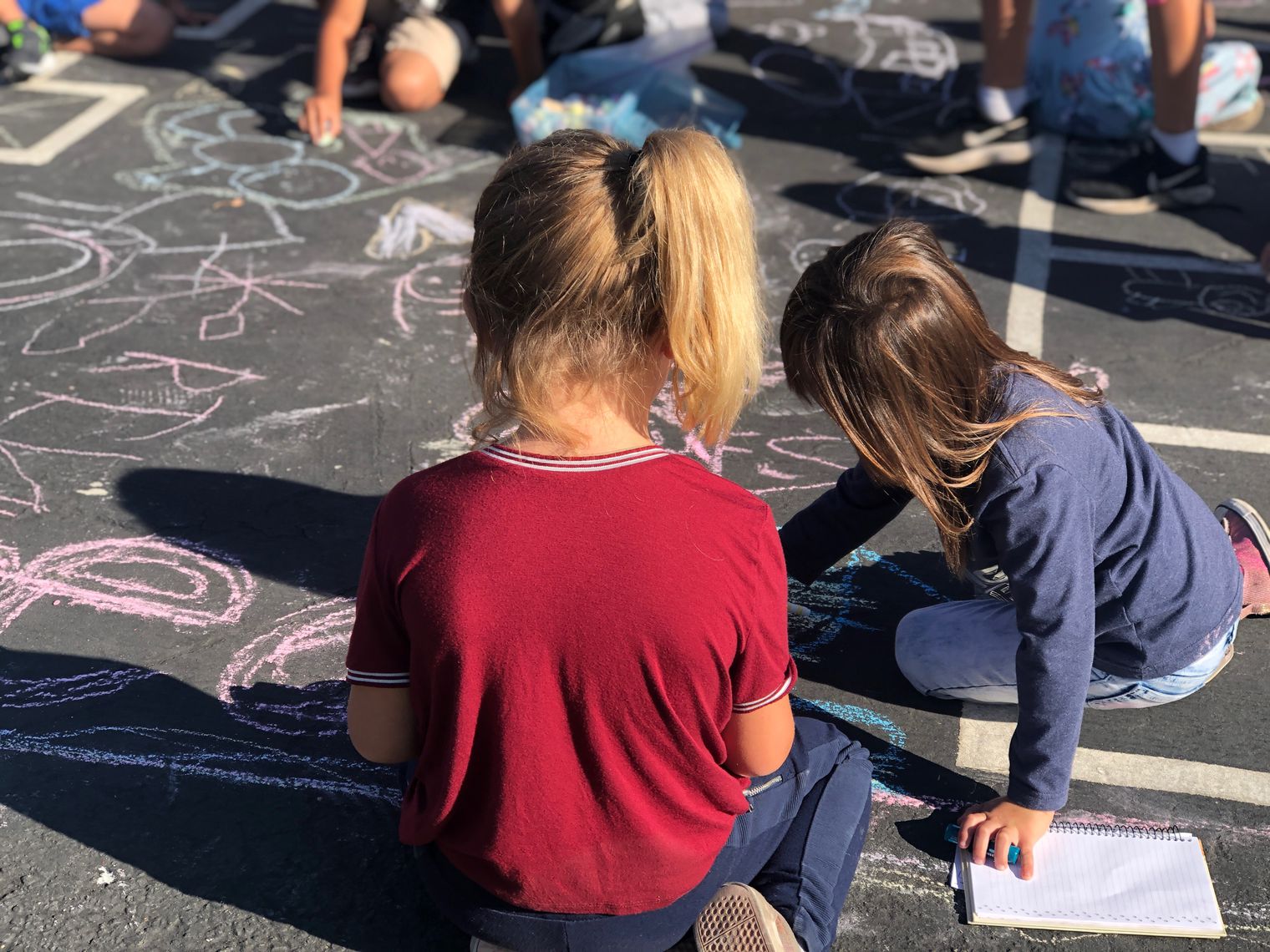 Two students playing with Chalk