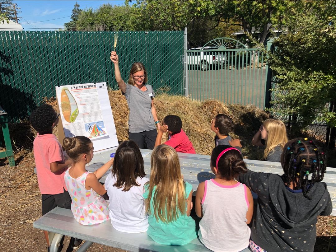 A teacher with students outside.