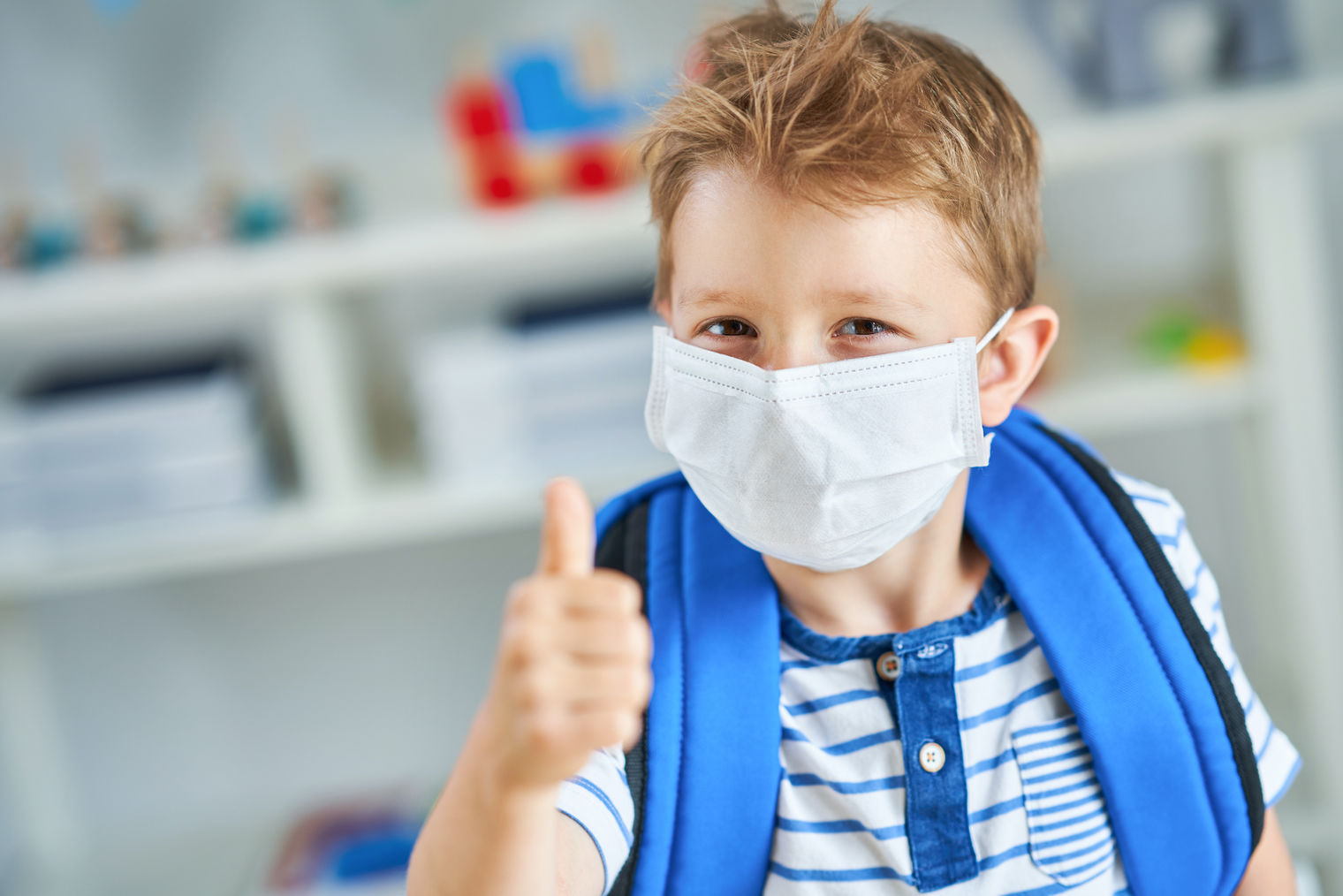 Child doing thumbs up