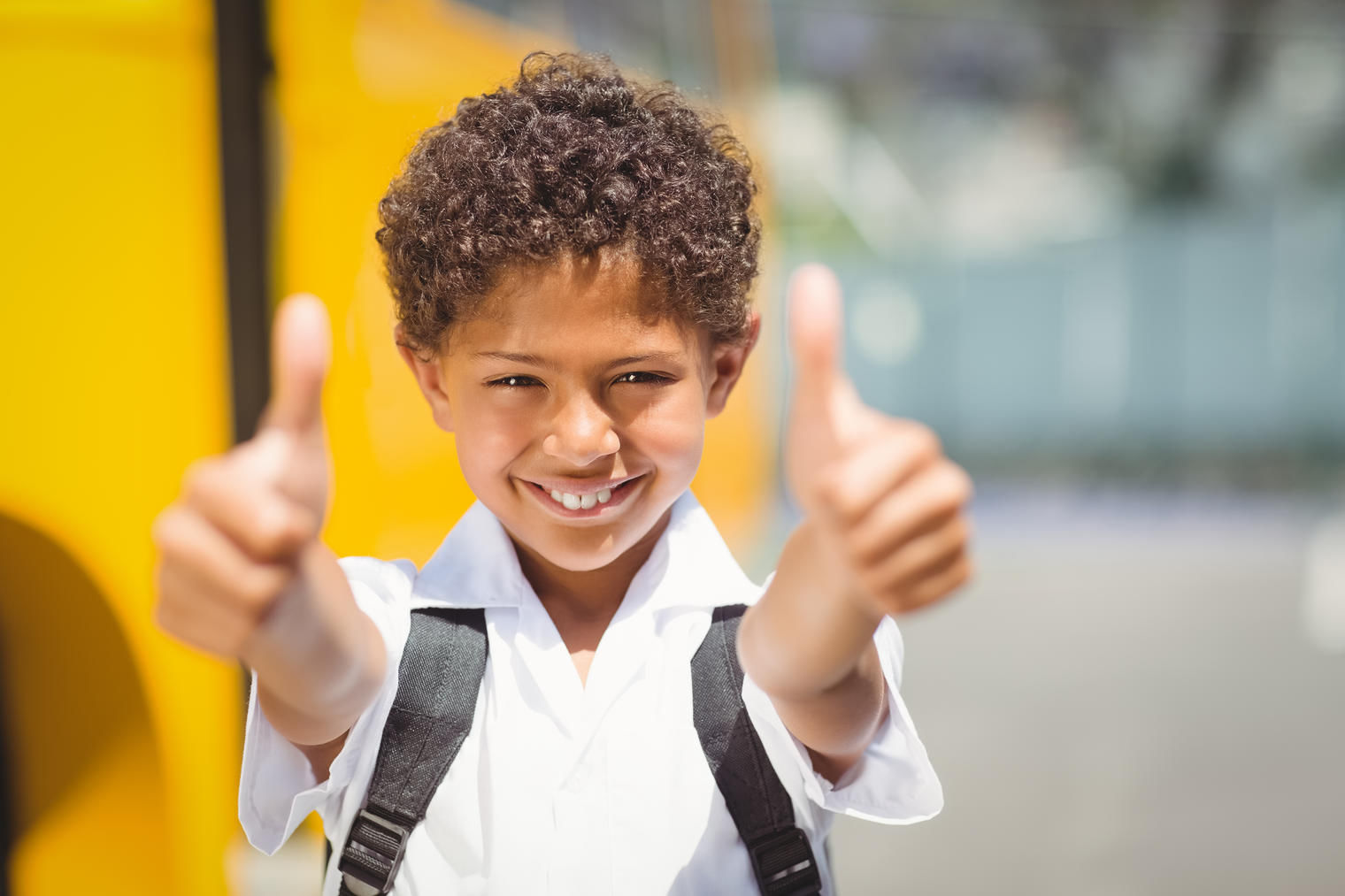 child with both thumbs up