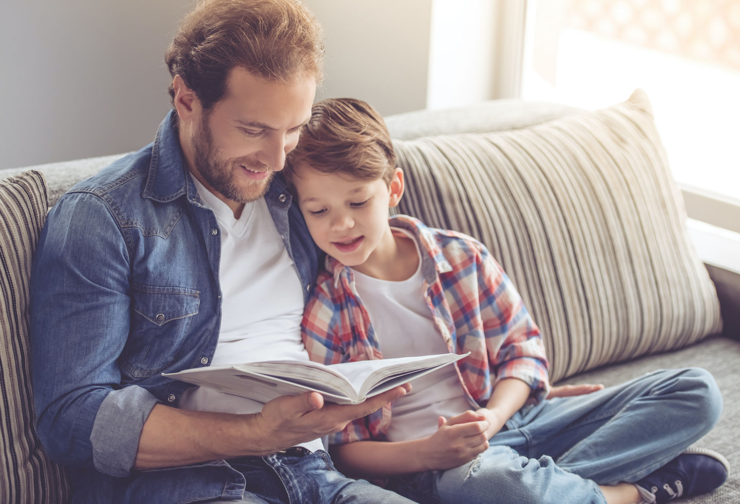 Dad and son reading a book