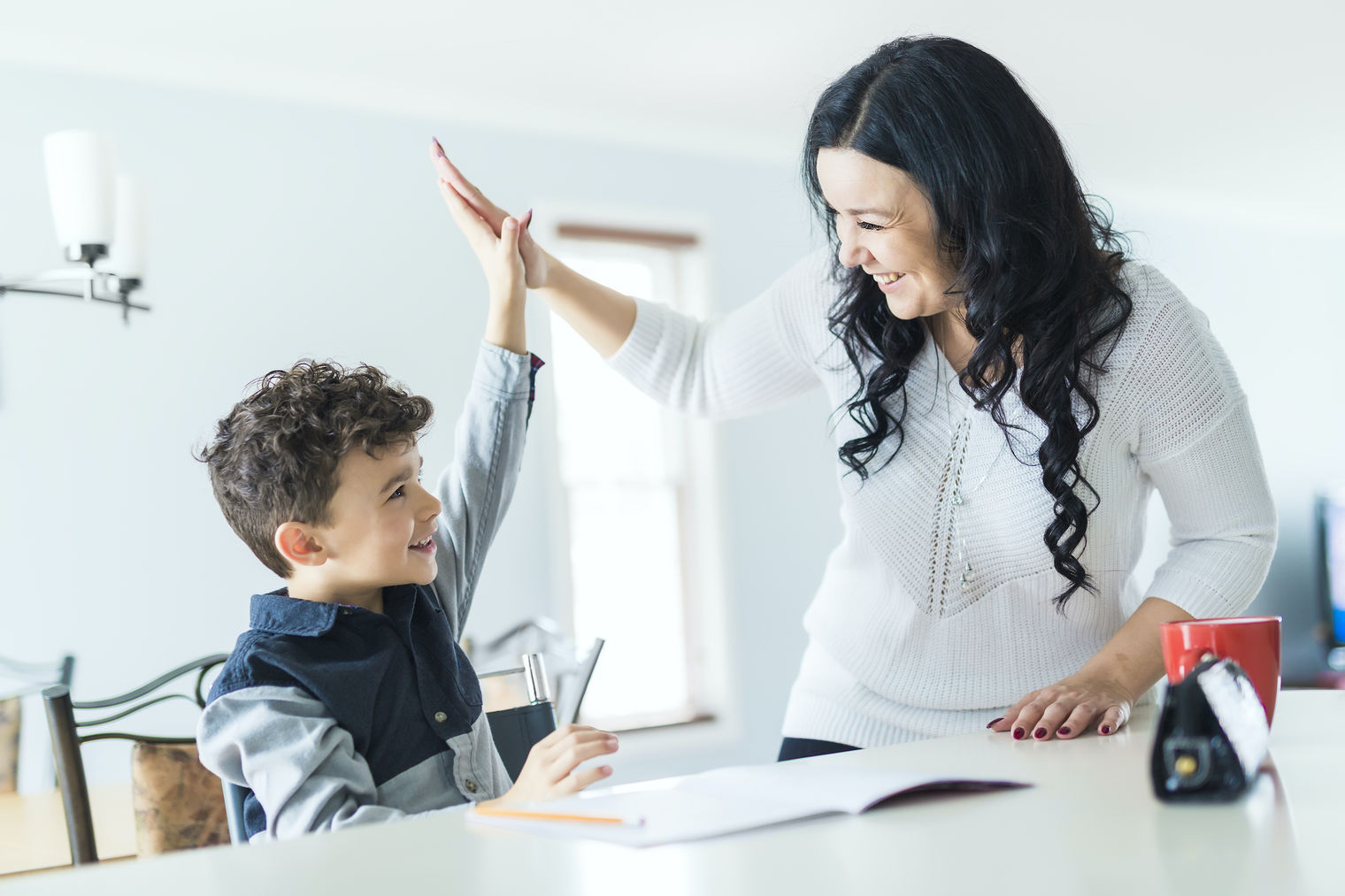 Student and parent high fiving.