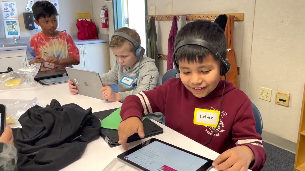 student smiling while listening to beat he made