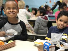 Two boys eating lunch