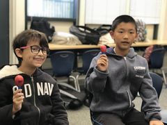 Two students in music class