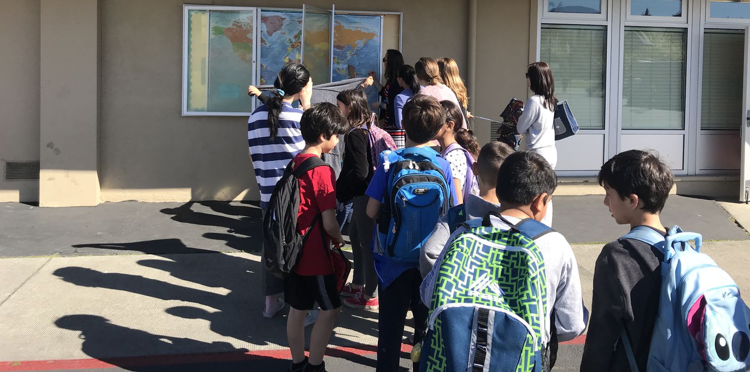 Students lined up at a map