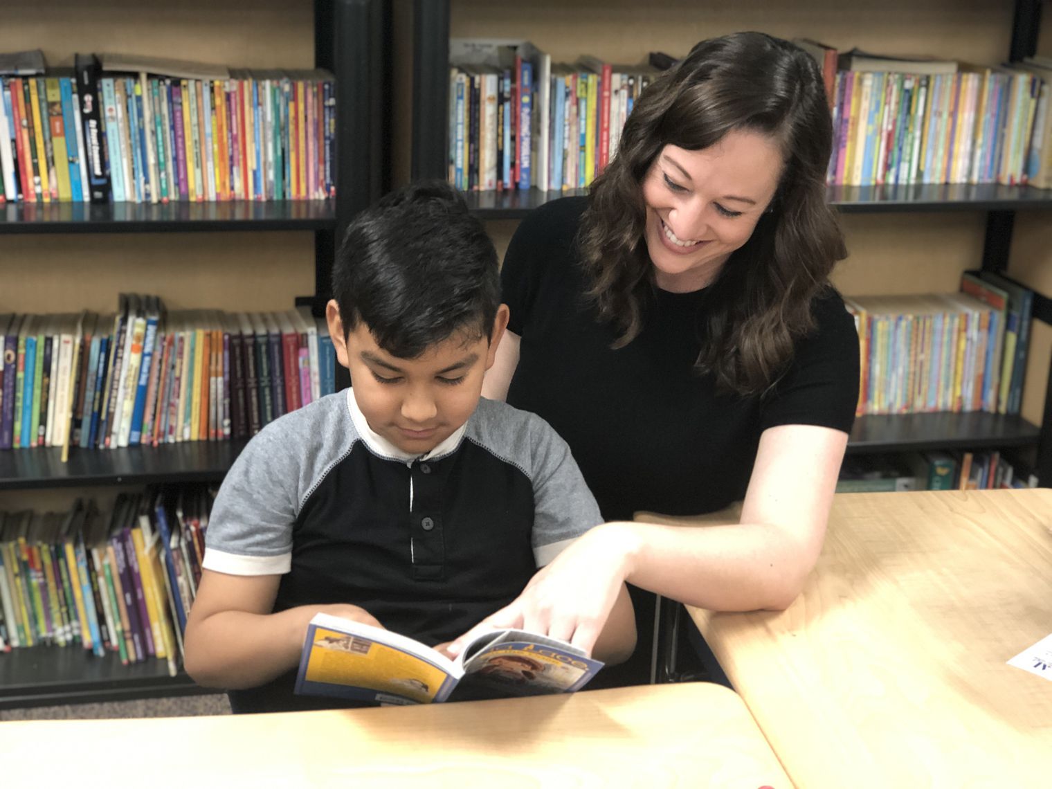 Mrs. Wellendorf with a student reading