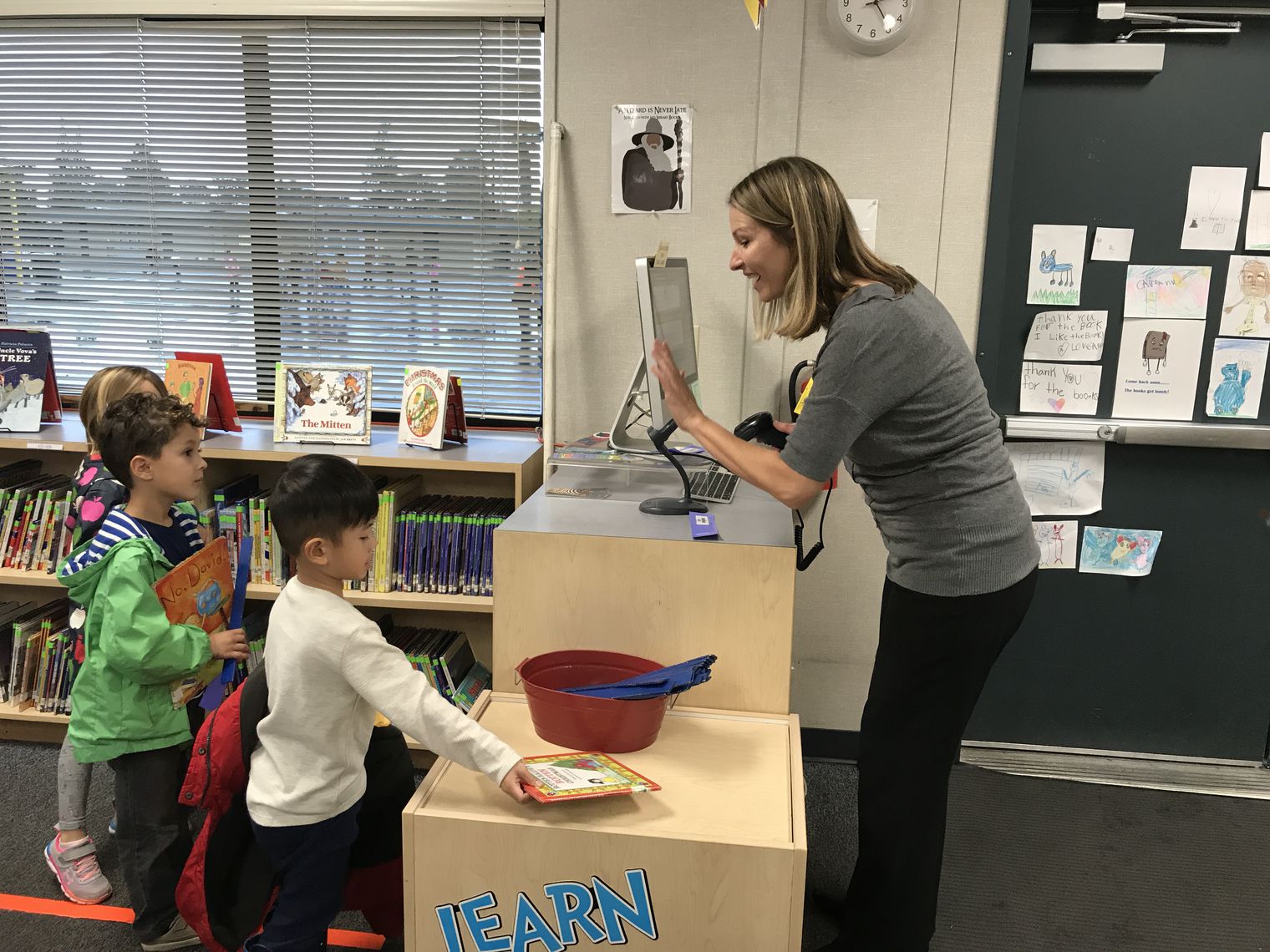 Volunteer checking out books in the library